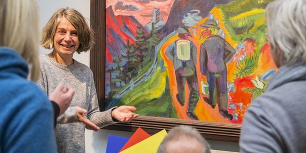 Visitors infront of a painting